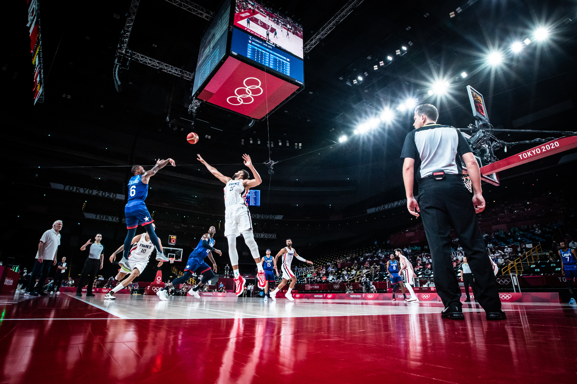 Basketball referee officiating during a game in a large arena